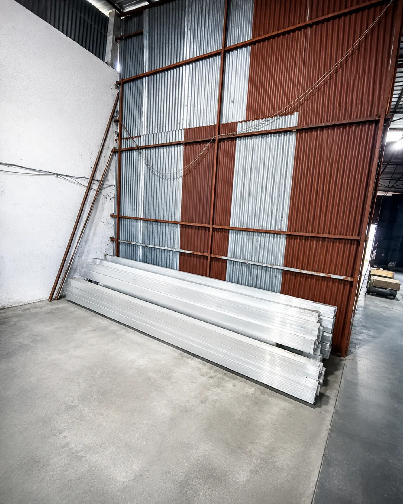 Long aluminium profiles stored inside an industrial workshop